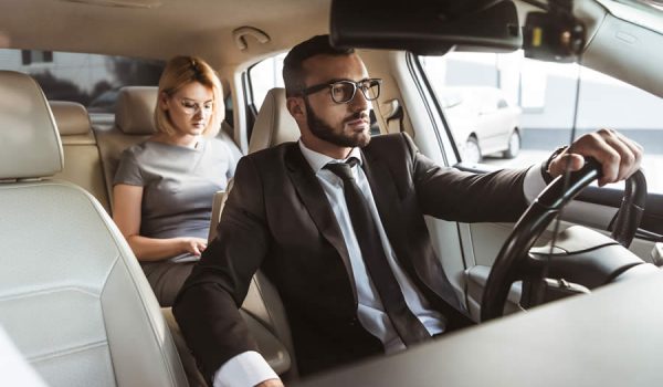 handsome-driver-and-attractive-businesswoman-in-ca-2021-08-29-22-35-53-utc